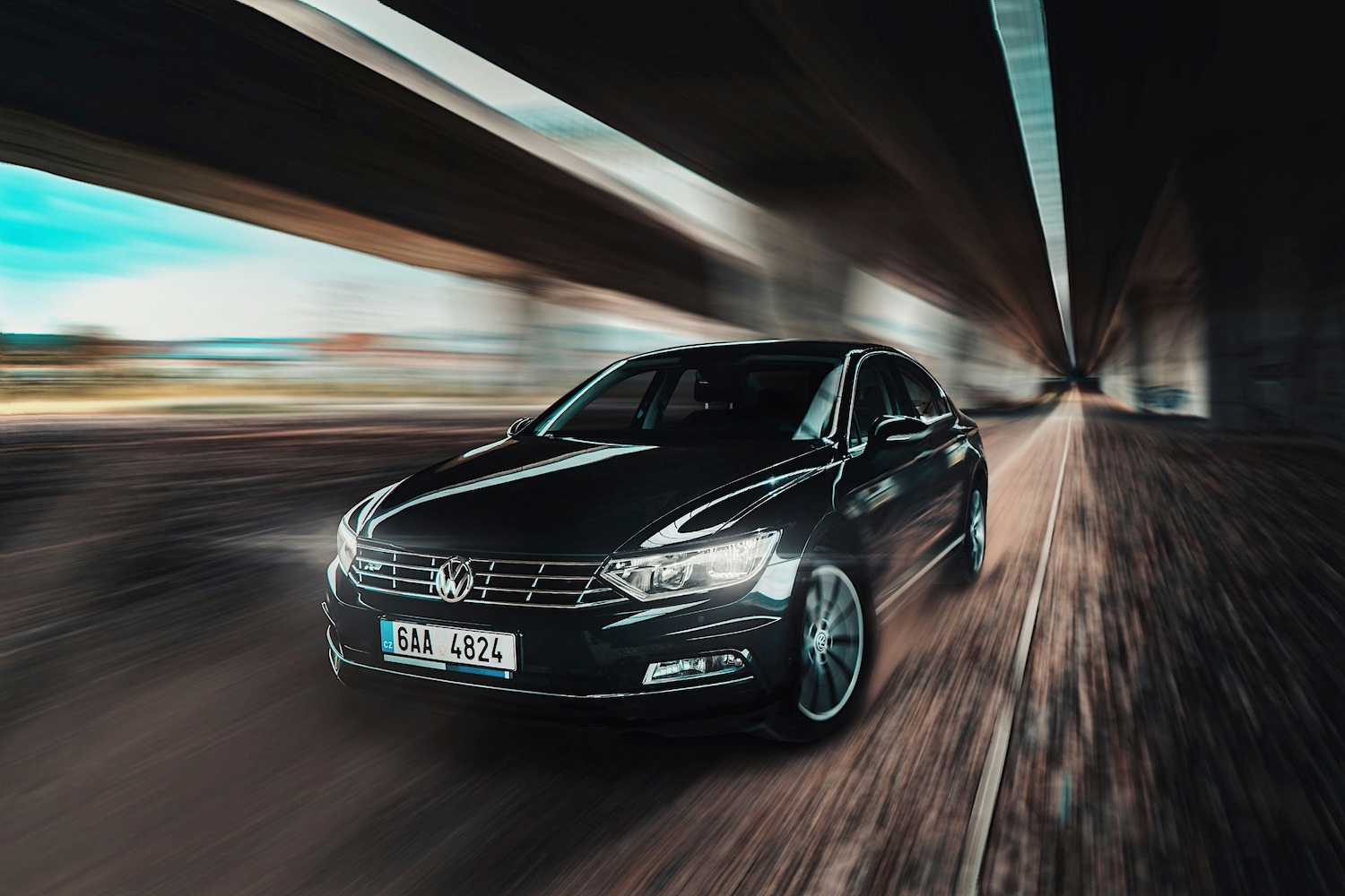 New Volkswagen fleet car being driven under a motorway underpass